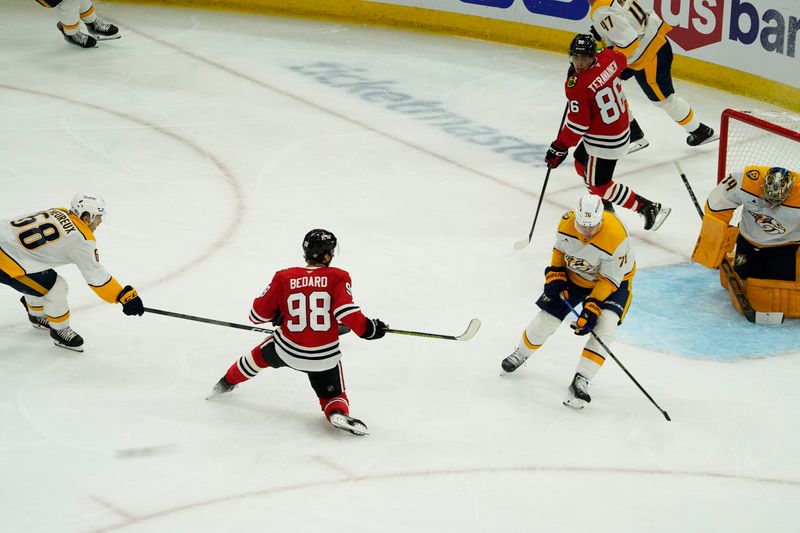 Oct 25, 2024; Chicago, Illinois, USA; Chicago Blackhawks center Connor Bedard (98) scores a goal on Nashville Predators goaltender Juuse Saros (74) during the second period at the United Center. Mandatory Credit: David Banks-Imagn Images