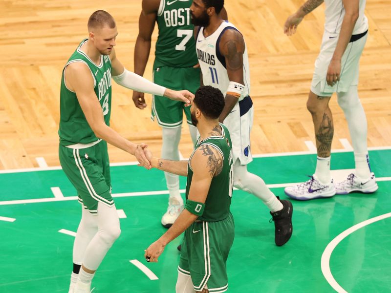 BOSTON, MA - JUNE 17: Kristaps Porzingis #8 of the Boston Celtics and Jayson Tatum #0 of the Boston Celtics high five during the game  against the Dallas Mavericks during Game 5 of the 2024 NBA Finals on June 17, 2024 at the TD Garden in Boston, Massachusetts. NOTE TO USER: User expressly acknowledges and agrees that, by downloading and or using this photograph, User is consenting to the terms and conditions of the Getty Images License Agreement. Mandatory Copyright Notice: Copyright 2024 NBAE  (Photo by Stephen Gosling/NBAE via Getty Images)
