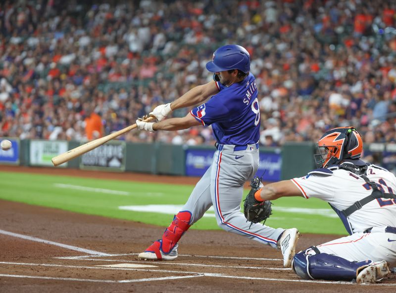 Apr 13, 2024; Houston, Texas, USA;  Texas Rangers third baseman Josh Smith (8) hits an RBI single against the Houston Astros in the first inning at Minute Maid Park. Mandatory Credit: Thomas Shea-USA TODAY Sports