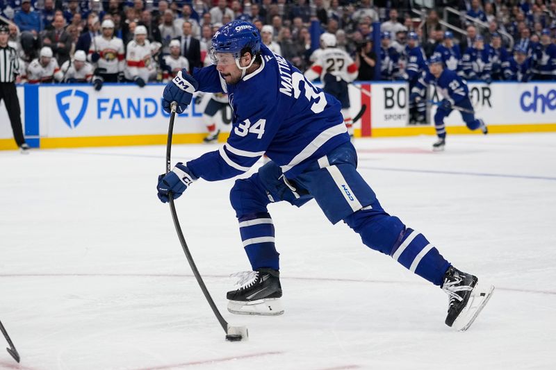 May 5, 2025; Toronto, Ontario, CAN; Toronto Maple Leafs forward Auston Matthews (34) shoots against the Florida Panthers during the third period of the second round of the 2025 Stanley Cup Playoffs at Scotiabank Arena. Mandatory Credit: John E. Sokolowski-Imagn Images