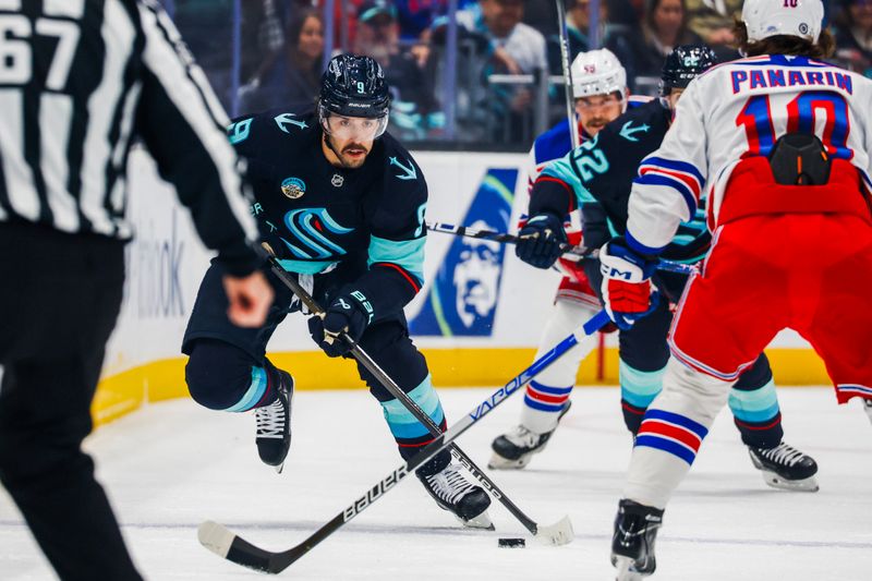 Nov 17, 2024; Seattle, Washington, USA; Seattle Kraken center Chandler Stephenson (9) skates with the puck against the New York Rangers during the first period at Climate Pledge Arena. Mandatory Credit: Joe Nicholson-Imagn Images