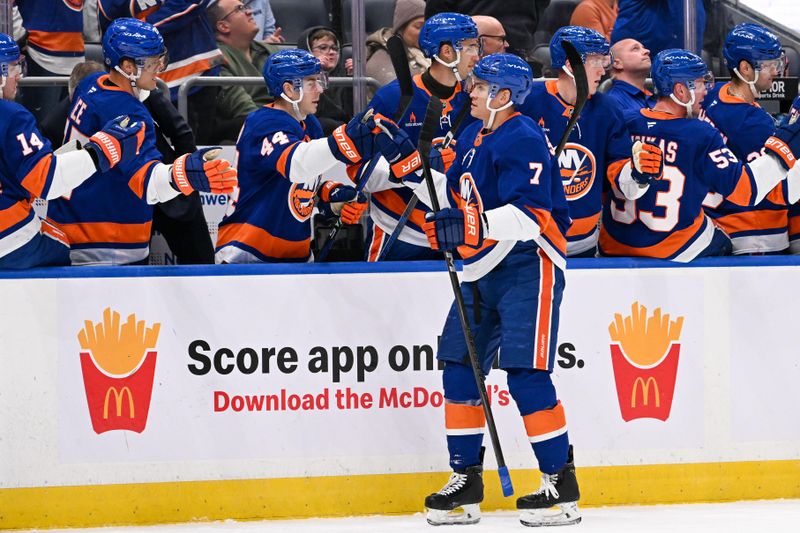 Nov 27, 2024; Elmont, New York, USA;  New York Islanders right wing Maxim Tsyplakov (7) celebrates his goal against the Boston Bruins during the first period at UBS Arena. Mandatory Credit: Dennis Schneidler-Imagn Images