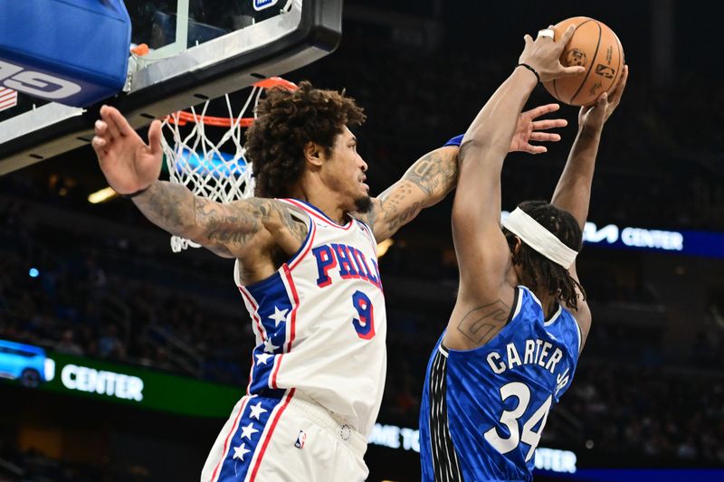 ORLANDO, FLORIDA - JANUARY 19: Wendell Carter Jr. #34 of the Orlando Magic draws the foul from Kelly Oubre Jr. #9 of the Philadelphia 76ers in the second half of a game at Kia Center on January 19, 2024 in Orlando, Florida. NOTE TO USER: User expressly acknowledges and agrees that, by downloading and or using this photograph, User is consenting to the terms and conditions of the Getty Images License Agreement. (Photo by Julio Aguilar/Getty Images)