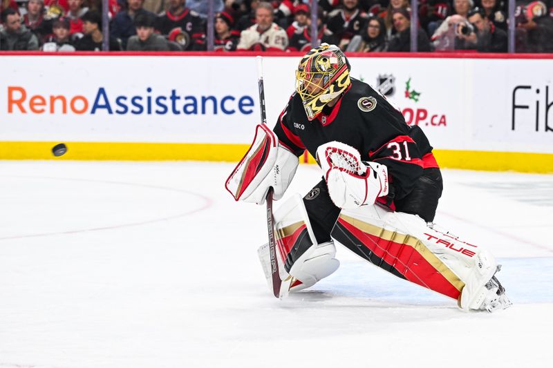 Nov 25, 2024; Ottawa, Ontario, CAN; Ottawa Senators goalie Anton Forsberg (31) tracks the puck against the Calgary Flames during the second period at Canadian Tire Centre. Mandatory Credit: David Kirouac-Imagn Images