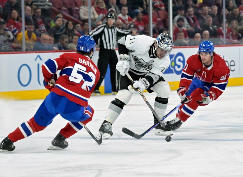 Dec 7, 2023; Montreal, Quebec, CAN; Los Angeles Kings forward Anze Kopitar (11) plays the puck as Montreal Canadiens defenseman Justin Barron (52) defends with teammate forward Sean Monahan (91) during the first period at the Bell Centre. Mandatory Credit: Eric Bolte-USA TODAY Sports