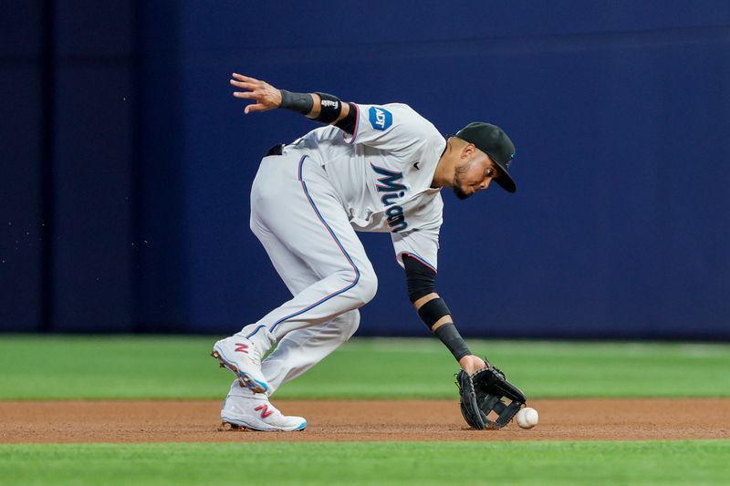 Jun 4, 2023; Miami, Florida, USA; Miami Marlins second baseman Luis Arraez (3) catches a ground ball prior to throwing it to first base to retire Oakland Athletics first baseman Ryan Noda (not pictured) during the first inning at loanDepot Park. Mandatory Credit: Sam Navarro-USA TODAY Sports