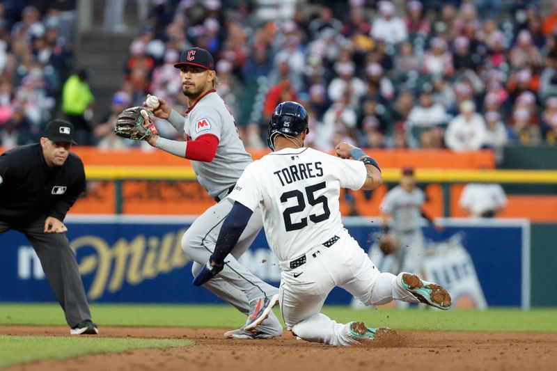 May 24, 2025; Detroit, Michigan, USA; Cleveland Guardians second baseman Gabriel Arias (13) throws to first after tagging Detroit Tigers second base Gleyber Torres (25) out at second during the fifth inning at Comerica Park. Mandatory Credit: Brian Bradshaw Sevald-Imagn Images