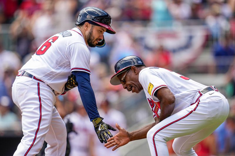 May 21, 2023; Cumberland, Georgia, USA; Atlanta Braves catcher Travis d'Arnaud (16) reacts with third base coach Ron Washington (37) after hitting a home run against the Seattle Mariners during the sixth inning at Truist Park. Mandatory Credit: Dale Zanine-USA TODAY Sports