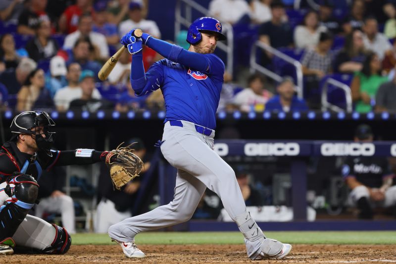 Aug 23, 2024; Miami, Florida, USA; Chicago Cubs right fielder Cody Bellinger (24) hits a double against the Miami Marlins during the fifth inning at loanDepot Park. Mandatory Credit: Sam Navarro-USA TODAY Sports