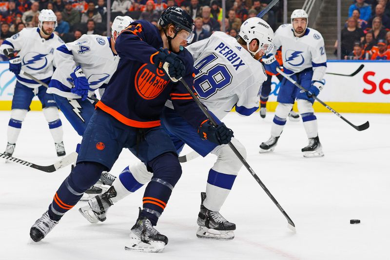 Dec 14, 2023; Edmonton, Alberta, CAN; Edmonton Oilers forward Warren Foegele (37) and Tampa Bay Lightning defensemen Nick Perbix (48) battle for a loose puck during the first period at Rogers Place. Mandatory Credit: Perry Nelson-USA TODAY Sports