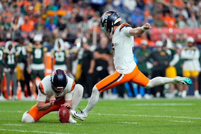 Denver Broncos kicker Wil Lutz, right, kicks a field goal during the first half of a preseason NFL football game against the Green Bay Packers, Sunday, Aug. 18, 2024, in Denver. (AP Photo/Jack Dempsey)