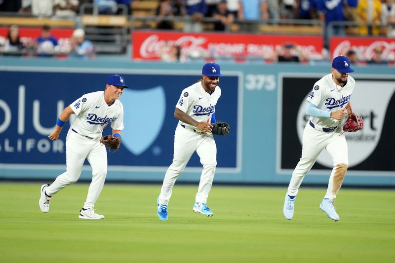 Aug 8, 2025; Los Angeles, California, USA; Los Angeles Dodgers left fielder Alex Call (left), center fielder Justin Dean (75) and center fielder Andy Pages (44) react at the end of the game against the Toronto Blue Jays at Dodger Stadium. Mandatory Credit: Kirby Lee-Imagn Images