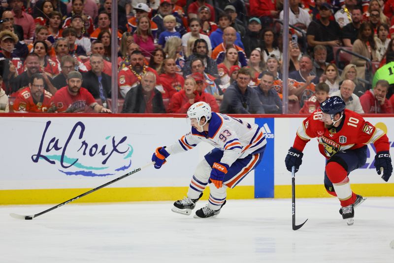 Jun 24, 2024; Sunrise, Florida, USA; Edmonton Oilers forward Ryan Nugent-Hopkins (93) reaches for the puck defended by Florida Panthers forward Vladimir Tarasenko (10) during the first period in game seven of the 2024 Stanley Cup Final at Amerant Bank Arena. Mandatory Credit: Sam Navarro-USA TODAY Sports