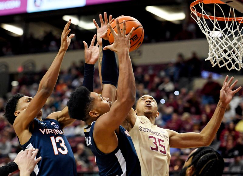 Jan 14, 2023; Tallahassee, Florida, USA; Virginia Cavaliers guard Ryan Dunn (13) and forward Jayden Gardner (1) fight for a rebound with Florida State Seminoles guard Matthew Cleveland (35) during the second half at Donald L. Tucker Center. Mandatory Credit: Melina Myers-USA TODAY Sports