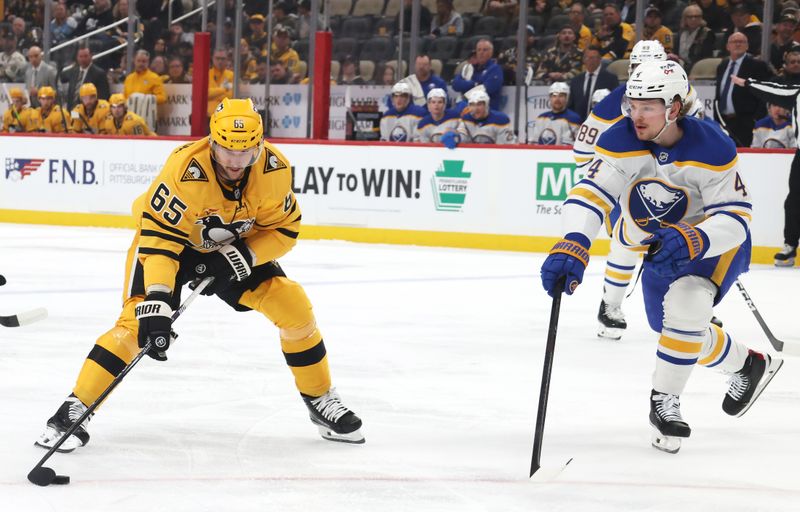 Mar 5, 2026; Pittsburgh, Pennsylvania, USA;  Pittsburgh Penguins defenseman Erik Karlsson (65) moves the puck against Buffalo Sabres defenseman Bowen Byram (4) during the first period at PPG Paints Arena. Mandatory Credit: Charles LeClaire-Imagn Images