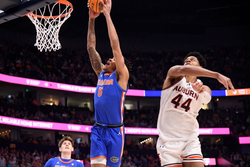 Mar 17, 2024; Nashville, TN, USA; Auburn Tigers center Dylan Cardwell (44) fouls Florida Gators guard Will Richard (5) in the first half in the SEC Tournament championship game at Bridgestone Arena. Mandatory Credit: Steve Roberts-USA TODAY Sports