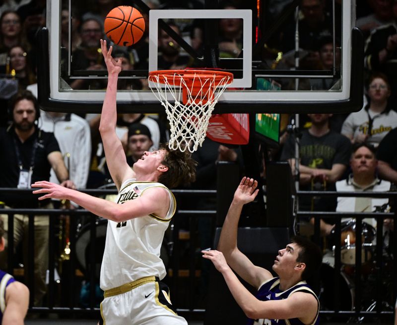 Jan 7, 2026; West Lafayette, Indiana, USA; Purdue Boilermakers center Daniel Jacobsen (12) shoots the ball in front of Washington Huskies forward Nikola Dzepina (33) during the first half at Mackey Arena. Mandatory Credit: Marc Lebryk-Imagn Images