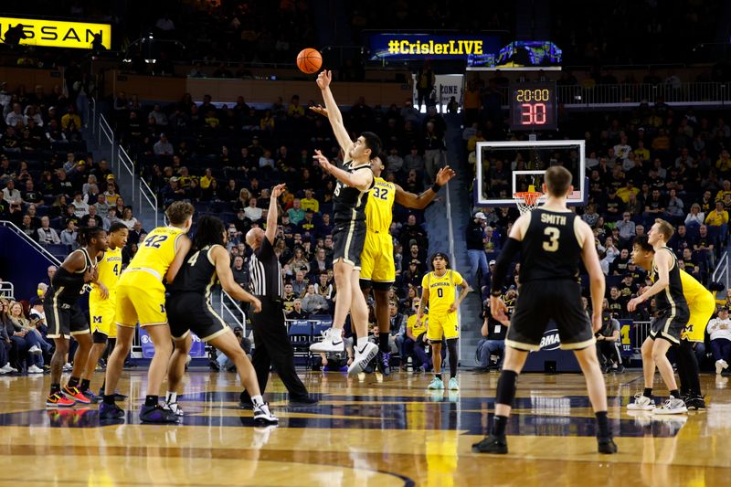 Feb 25, 2024; Ann Arbor, Michigan, USA;  Purdue Boilermakers center Zach Edey (15) and Michigan Wolverines forward Tarris Reed Jr. (32) tip off in the first half at Crisler Center. Mandatory Credit: Rick Osentoski-USA TODAY Sports