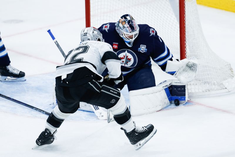 Jan 9, 2026; Winnipeg, Manitoba, CAN; Winnipeg Jets goalie Eric Comrie (1) makes a save on a shot by Los Angeles Kings forward Kevin Fiala (22) during the third period at Canada Life Centre. Mandatory Credit: Terrence Lee-Imagn Images