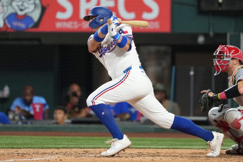 Sep 7, 2024; Arlington, Texas, USA; Texas Rangers third baseman Josh Jung (6) follows through on his single against the Los Angeles Angels during the sixth inning at Globe Life Field. Mandatory Credit: Jim Cowsert-Imagn Images