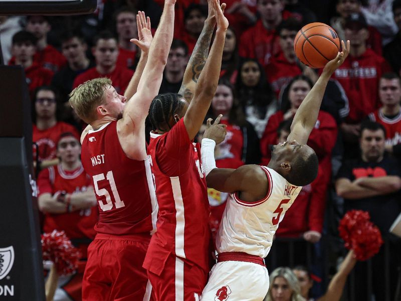 Jan 17, 2024; Piscataway, New Jersey, USA; Rutgers Scarlet Knights forward Aundre Hyatt (5) shoots the ball as Nebraska Cornhuskers forward Rienk Mast (51) and guard Brice Williams (3) defend during the first half at Jersey Mike's Arena. Mandatory Credit: Vincent Carchietta-USA TODAY Sports