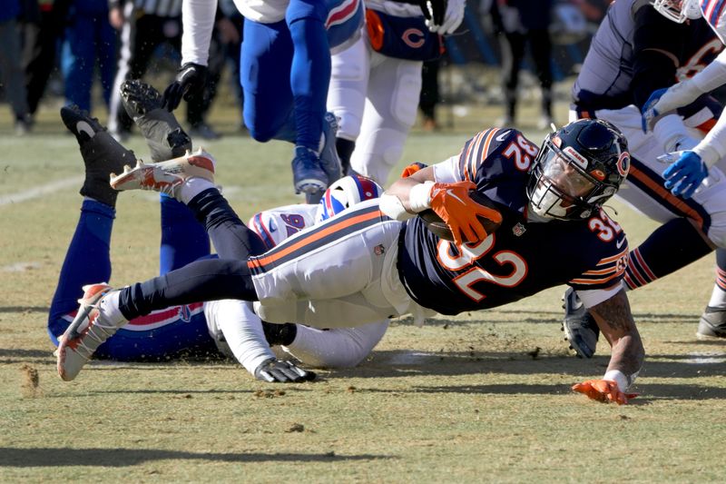 Chicago Bears' David Montgomery stretches for extra yardage during an NFL football game against the Buffalo Bills Saturday, Dec. 24, 2022, in Chicago. The Bills won 35-13. (AP Photo/Charles Rex Arbogast)