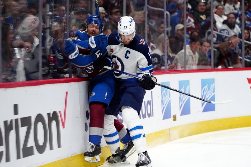 Apr 28, 2024; Denver, Colorado, USA; Winnipeg Jets center Adam Lowry (17) checks Colorado Avalanche defenseman Samuel Girard (49) during the first period in game four of the first round of the 2024 Stanley Cup Playoffs at Ball Arena. Mandatory Credit: Ron Chenoy-USA TODAY Sports