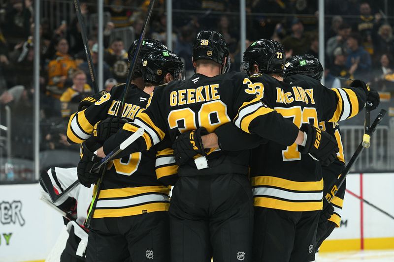 Oct 9, 2025; Boston, Massachusetts, USA; Boston Bruins center Morgan Geekie (39) celebrates a goal by center Elias Lindholm (28) with his linemates during the third period against the Chicago Blackhawks at TD Garden. Mandatory Credit: Bob DeChiara-Imagn Images
