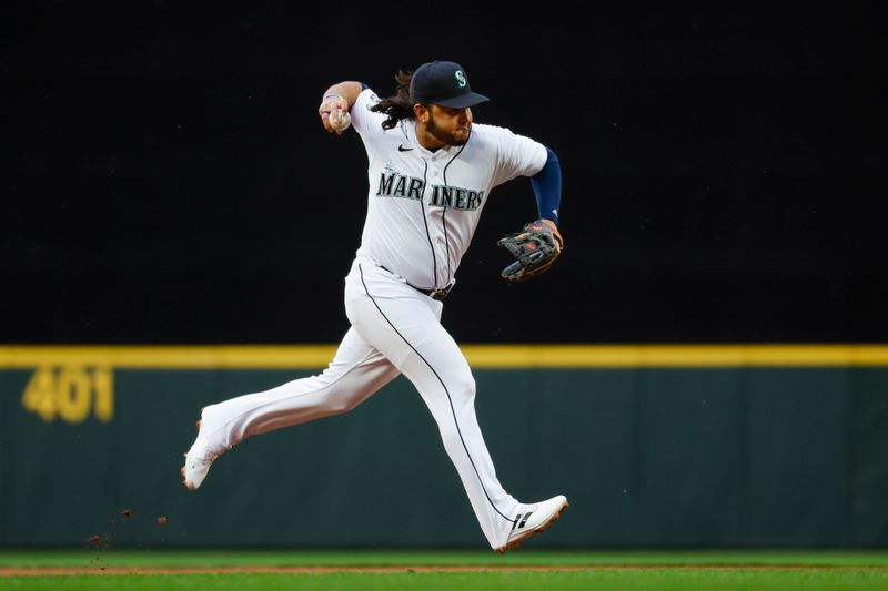 Jun 13, 2023; Seattle, Washington, USA; Seattle Mariners third baseman Eugenio Suarez (28) throws to first base for a groundout against the Miami Marlins during the third inning at T-Mobile Park. Mandatory Credit: Joe Nicholson-USA TODAY Sports