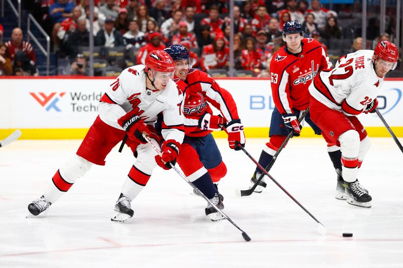 Mar 22, 2024; Washington, District of Columbia, USA; Carolina Hurricanes defenseman Brady Skjei (76) battles for the puck with Washington Capitals center Dylan Strome (17) during the third period at Capital One Arena. Mandatory Credit: Amber Searls-USA TODAY Sports