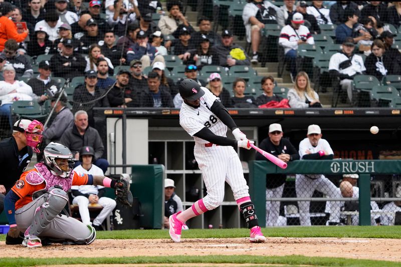 May 14, 2023; Chicago, Illinois, USA; Chicago White Sox center fielder Luis Robert Jr. (88) hits a home run against the Houston Astros during the fourth inning at Guaranteed Rate Field. Mandatory Credit: David Banks-USA TODAY Sports