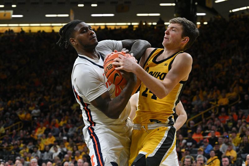 Mar 10, 2024; Iowa City, Iowa, USA; Illinois Fighting Illini forward Dain Dainja (42) and Iowa Hawkeyes forward Pryce Sandfort (24) battle for a loose ball during the second half at Carver-Hawkeye Arena. Mandatory Credit: Jeffrey Becker-USA TODAY Sports