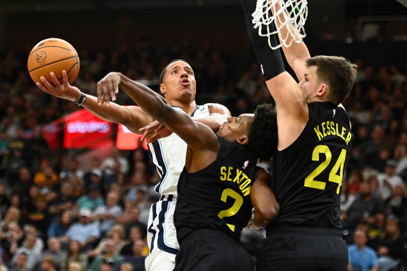 SALT LAKE CITY, UTAH - OCTOBER 23: Desmond Bane #22 of the Memphis Grizzlies drives to the basket against Collin Sexton #2 and Walker Kessler #24 of the Utah Jazz during the fourth quarter at Delta Center on October 23, 2024 in Salt Lake City, Utah. NOTE TO USER: User expressly acknowledges and agrees that, by downloading and or using this photograph, User is consenting to the terms and conditions of the Getty Images License Agreement. (Photo by Alex Goodlett/Getty Images)