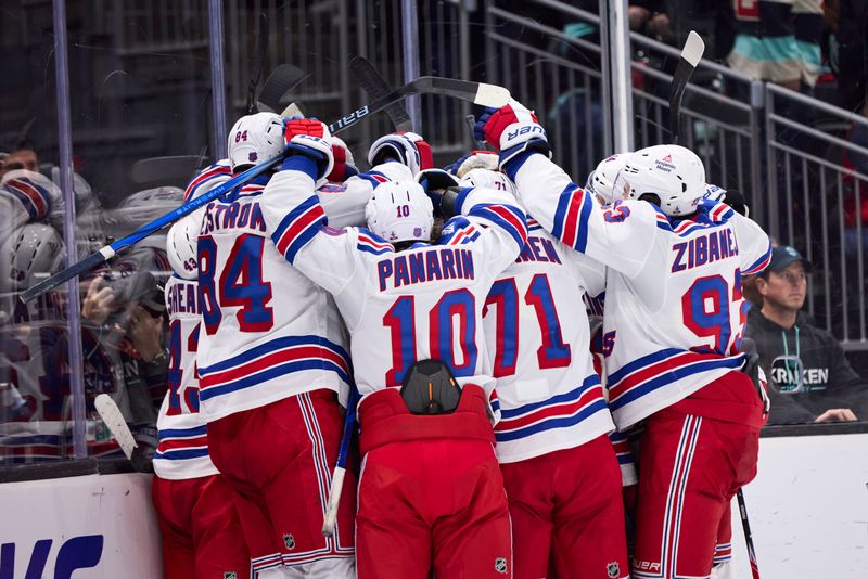 Nov 1, 2025; Seattle, Washington, USA;  The New York Rangers celebrate an overtime win against the Seattle Kraken at Climate Pledge Arena. Mandatory Credit: Blake Dahlin-Imagn Images