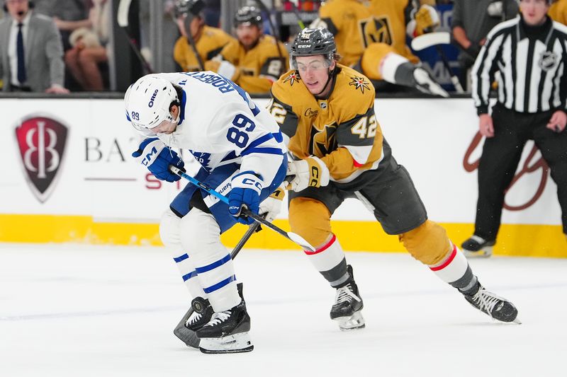 Jan 15, 2026; Las Vegas, Nevada, USA; Toronto Maple Leafs left wing Nicholas Robertson (89) protects the puck from Vegas Golden Knights right wing Braeden Bowman (42) during the second period at T-Mobile Arena. Mandatory Credit: Stephen R. Sylvanie-Imagn Images