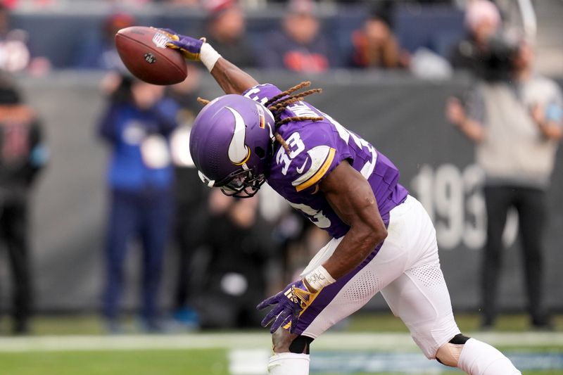 Minnesota Vikings running back Aaron Jones (33) spikes the ball after scoring during the second half of an NFL football game against the Chicago Bears, Sunday, Nov. 24, 2024, in Chicago. (AP Photo/Erin Hooley)