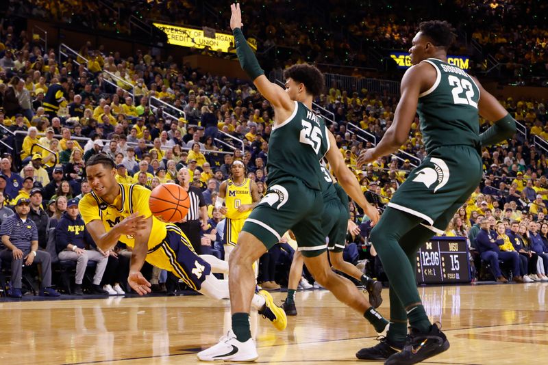 Feb 18, 2023; Ann Arbor, Michigan, USA; Michigan Wolverines guard Jett Howard (13) passes the ball against Michigan State Spartans forward Malik Hall (25) in the first half  at Crisler Center. Mandatory Credit: Rick Osentoski-USA TODAY Sports