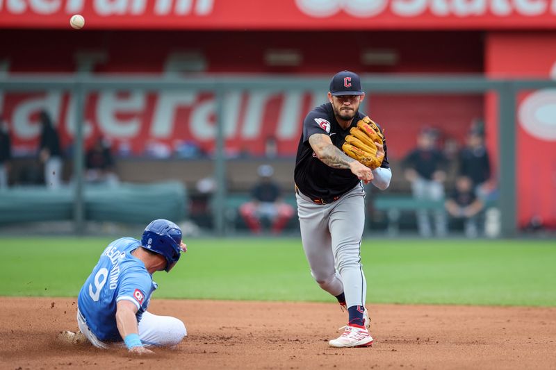 Jun 28, 2023; Kansas City, Missouri, USA; Cleveland Guardians third base Gabriel Arias (13) throws to first base over Kansas City Royals first base Vinnie Pasquantino (9) during the fifth inning at Kauffman Stadium. Mandatory Credit: William Purnell-USA TODAY Sports