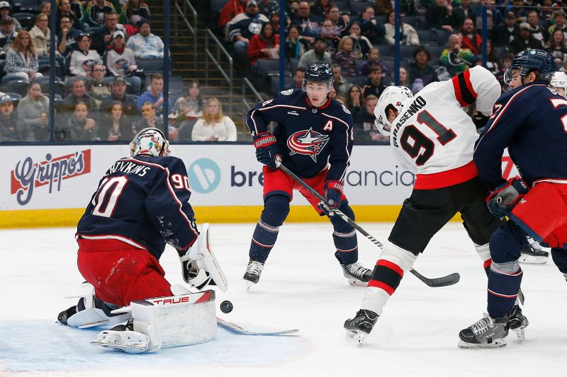 Dec 1, 2023; Columbus, Ohio, USA; Columbus Blue Jackets goalie Elvis Merzlikins (90) makes a save as Ottawa Senators right wing Vladimir Tarasenko (91) looks for a rebound during the first period at Nationwide Arena. Mandatory Credit: Russell LaBounty-USA TODAY Sports