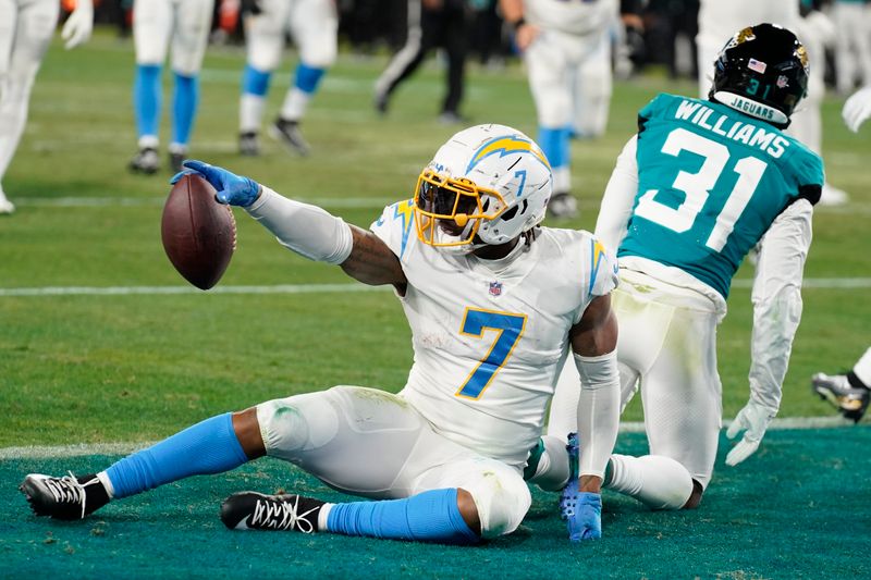 Los Angeles Chargers tight end Gerald Everett (7) celebrates his touchdown against the Jacksonville Jaguars during the first half of an NFL wild-card football game, Saturday, Jan. 14, 2023, in Jacksonville, Fla. (AP Photo/Chris O'Meara)