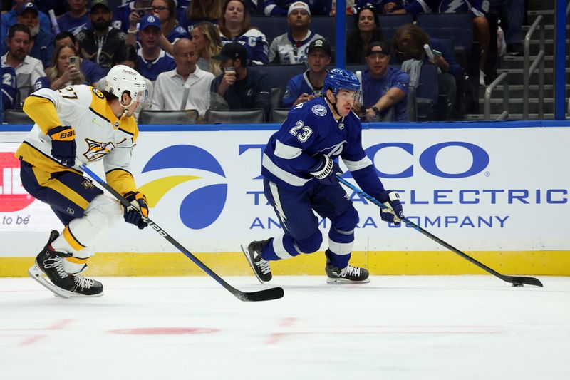 Oct 10, 2023; Tampa, Florida, USA; Tampa Bay Lightning center Michael Eyssimont (23) skates with the puck as Nashville Predators defenseman Ryan McDonagh (27) defends during the first period at Amalie Arena. Mandatory Credit: Kim Klement Neitzel-USA TODAY Sports