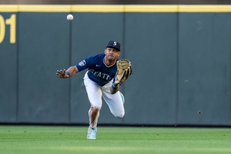 Aug 8, 2023; Seattle, Washington, USA; Seattle Mariners centerfielder Julio Rodriguez (44) catches a ball hit by San Diego Padres designated hitter Garrett Cooper (24) during the third inning at T-Mobile Park. Mandatory Credit: Stephen Brashear-USA TODAY Sports