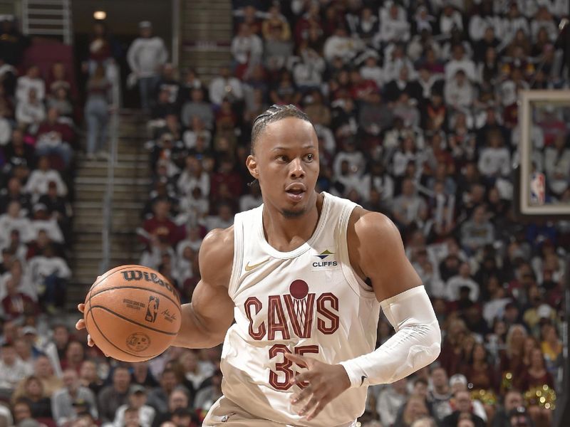 CLEVELAND, OH - APRIL 20: Isaac Okoro #35 of the Cleveland Cavaliers handles the ball during Round 1 Game 1 against the Orlando Magic of the 2024 NBA Playoffs on April 20, 2024 at Rocket Mortgage FieldHouse in Cleveland, Ohio. NOTE TO USER: User expressly acknowledges and agrees that, by downloading and/or using this Photograph, user is consenting to the terms and conditions of the Getty Images License Agreement. Mandatory Copyright Notice: Copyright 2024 NBAE (Photo by David Liam Kyle/NBAE via Getty Images)