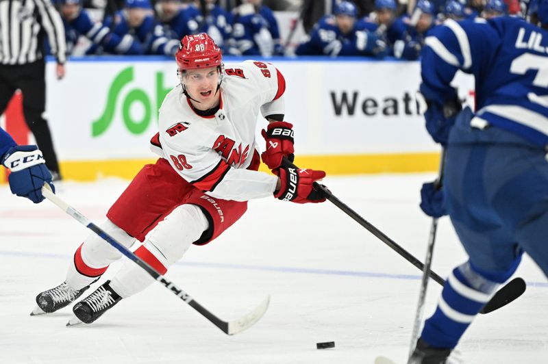 Dec 30, 2023; Toronto, Ontario, CAN; Carolina Hurricanes forward Martin Necas (88) skates with the puck against the Toronto Maple Leafs in the second period at Scotiabank Arena. Mandatory Credit: Dan Hamilton-USA TODAY Sports