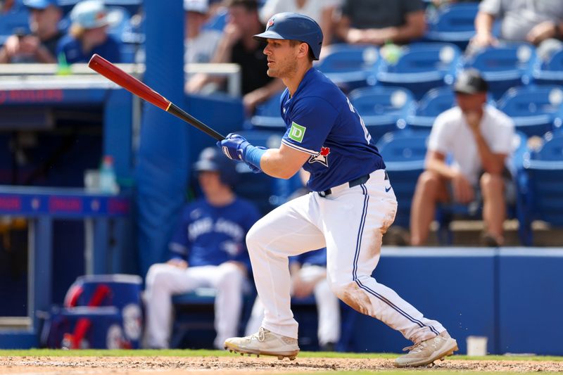 Mar 12, 2024; Dunedin, Florida, USA;  Toronto Blue Jays left fielder Daulton Varsho (25) hits an rbi single against the New York Yankees in the fifth inning at TD Ballpark. Mandatory Credit: Nathan Ray Seebeck-USA TODAY Sports