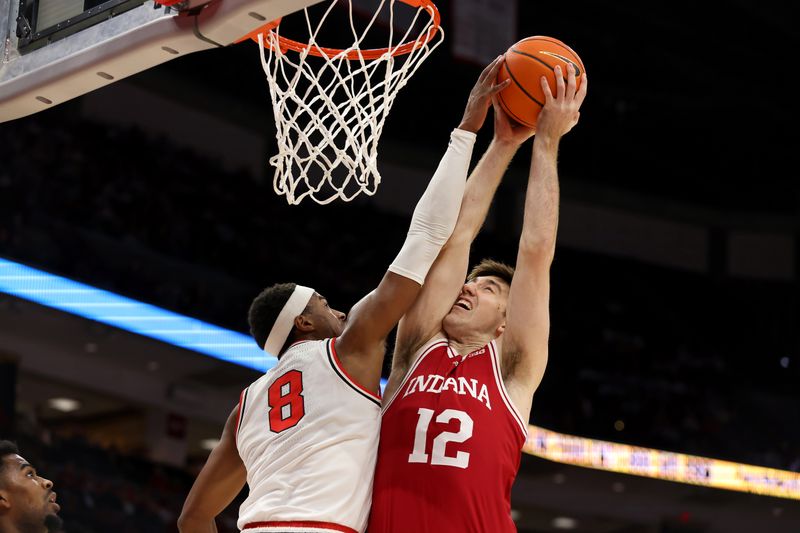 Jan 17, 2025; Columbus, Ohio, USA; Indiana Hoosiers center Langdon Hatton (12) has his shot blocked by Ohio State Buckeyes guard Micah Parrish (8) during the first half at Value City Arena. Mandatory Credit: Joseph Maiorana-Imagn Images