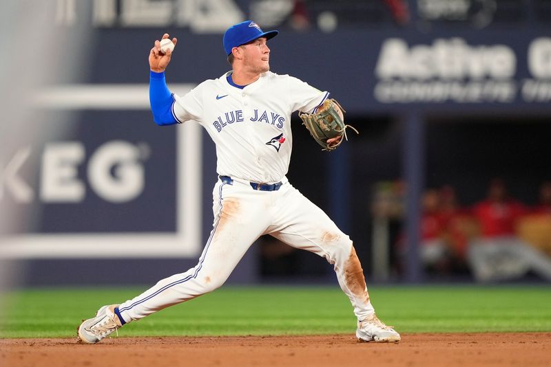 Aug 20, 2024; Toronto, Ontario, CAN; Toronto Blue Jays second baseman Will Wagner (7) throws to first base to put out Cincinnati Reds left fielder Spencer Steer (not pictured)during the second inning at Rogers Centre. Mandatory Credit: John E. Sokolowski-USA TODAY Sports