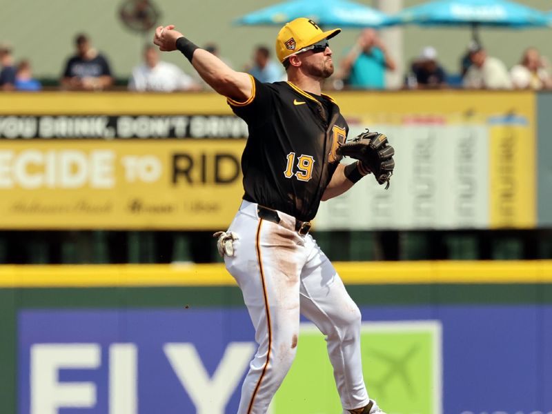 Mar 1, 2024; Bradenton, Florida, USA;  Pittsburgh Pirates third baseman Jared Triolo (19) throws the ball to first base for an out during the fourth inning at LECOM Park. Mandatory Credit: Kim Klement Neitzel-USA TODAY Sports