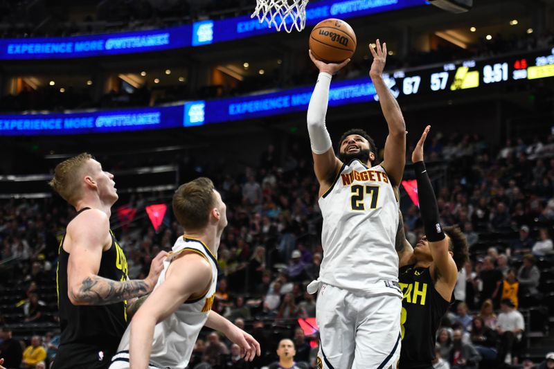 SALT LAKE CITY, UTAH - APRIL 09: Jamal Murray #27 of the Denver Nuggets shoots ahead of Keyonte George #3 of the Utah Jazz during the second half at Delta Center on April 09, 2024 in Salt Lake City, Utah. NOTE TO USER: User expressly acknowledges and agrees that, by downloading and or using this photograph, User is consenting to the terms and conditions of the Getty Images License Agreement.  (Photo by Alex Goodlett/Getty Images)