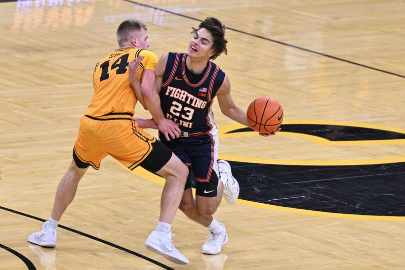 Jan 11, 2026; Iowa City, Iowa, USA; Illinois Fighting Illini guard Keaton Wagler (23) collides with Iowa Hawkeyes guard Bennett Stirtz (14) during the first half at Carver-Hawkeye Arena. Mandatory Credit: Jeffrey Becker-Imagn Images